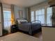 Comfortable bedroom featuring a bed, rug, hardwood floors, and bright windows at 1728 Newton St, Columbus, IN 47201