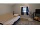 Bedroom featuring a comfortable bed, fan, and good natural light at 1728 Newton St, Columbus, IN 47201