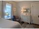 Bedroom featuring two windows with dressers and warm lighting at 1728 Newton St, Columbus, IN 47201