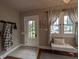 Cozy entryway featuring tiled floors, a coat rack, a bench, and natural light from a window at 1728 Newton St, Columbus, IN 47201