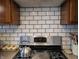A range with a kettle on it is accented by white subway tile at 1728 Newton St, Columbus, IN 47201