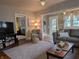 Stylish living room with plush seating, hardwood floors, and a view to the bedroom at 1728 Newton St, Columbus, IN 47201