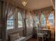 Bright sunroom with large windows, elegant curtains, a desk, and natural light at 1728 Newton St, Columbus, IN 47201