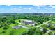 Overhead view showcasing the property's setting amid lush greenery and neighborhood, under a bright blue sky with scattered clouds at 1926 Fairmont Ct, Indianapolis, IN 46229