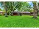 Large backyard with lush green lawn, mature trees, and room for outdoor entertaining at 1926 Fairmont Ct, Indianapolis, IN 46229