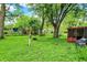Lush backyard with green grass, mature trees, and space for outdoor activities and relaxation at 1926 Fairmont Ct, Indianapolis, IN 46229