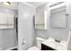 Well-lit bathroom featuring a toilet, sink with vanity, mirror, and white storage cabinets at 1926 Fairmont Ct, Indianapolis, IN 46229