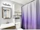 This bathroom has a vanity, mirror, shelf, cabinets, toilet, and shower with a curtain at 1926 Fairmont Ct, Indianapolis, IN 46229