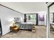A large gray bed sits in this carpeted bedroom with end tables, a window, and closet at 1926 Fairmont Ct, Indianapolis, IN 46229
