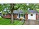 Charming brick home with a well-maintained front yard and mature tree at 1926 Fairmont Ct, Indianapolis, IN 46229