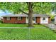 Brick home featuring a well-manicured lawn, mature tree, and inviting curb appeal at 1926 Fairmont Ct, Indianapolis, IN 46229