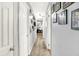 Hallway with carpeted floor, white doors, and photos hung along the wall leading into another room at 1926 Fairmont Ct, Indianapolis, IN 46229