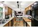 Open kitchen concept flowing into the dining area with cabinets, tile floors, and stainless steel appliances at 1926 Fairmont Ct, Indianapolis, IN 46229