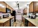 Traditional kitchen with wood cabinets, modern appliances, tile backsplash, and tiled flooring at 1926 Fairmont Ct, Indianapolis, IN 46229