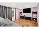 Comfortable living room with gray sofa, hardwood floors, TV, and glass sliding door to the backyard at 1926 Fairmont Ct, Indianapolis, IN 46229