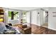 Bright living room with hardwood floors, a comfortable couch, and a large window providing natural light at 1926 Fairmont Ct, Indianapolis, IN 46229