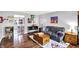 Spacious living room with hardwood floors, grey sofa, stylish décor, and an open view to the dining area at 1926 Fairmont Ct, Indianapolis, IN 46229