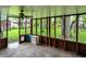 Relaxing screened porch with ceiling fan, rustic accents and backyard views at 1926 Fairmont Ct, Indianapolis, IN 46229