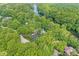 Stunning aerial view of home nestled among lush trees and winding river, providing a secluded and serene setting at 20322 Wagon Trail Dr, Noblesville, IN 46060