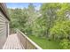 Tranquil view from the balcony overlooking a private backyard with lush greenery and a tire swing at 20322 Wagon Trail Dr, Noblesville, IN 46060