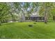 A house with a stone chimney, bay window, and a large backyard with a fire pit at 20322 Wagon Trail Dr, Noblesville, IN 46060
