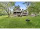 Large backyard with a deck, patio, tire swing, and wooded area at 20322 Wagon Trail Dr, Noblesville, IN 46060