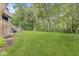 Expansive backyard featuring lush greenery and mature trees creates a private oasis, complete with an outdoor grill at 20322 Wagon Trail Dr, Noblesville, IN 46060