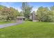 Charming home featuring a two-car garage, beautiful lawn, and mature trees offering both curb appeal and privacy at 20322 Wagon Trail Dr, Noblesville, IN 46060