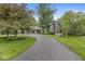 Beautiful home featuring manicured lawn, mature trees, and a long driveway leading to a spacious three-car garage at 20322 Wagon Trail Dr, Noblesville, IN 46060