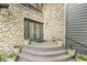 Inviting front entrance with decorative stone facade, stylish double doors, and colorful potted plants creating curb appeal at 20322 Wagon Trail Dr, Noblesville, IN 46060