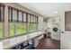 Bright laundry room featuring large windows, counter space, washing machine, and convenient storage solutions at 20322 Wagon Trail Dr, Noblesville, IN 46060
