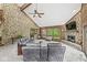 An expansive living room with stone walls, wood accents, fireplace, and large windows offering stunning natural views at 20322 Wagon Trail Dr, Noblesville, IN 46060