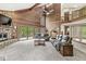 Bright living room with stone fireplace, vaulted ceilings, and access to outdoor deck at 20322 Wagon Trail Dr, Noblesville, IN 46060