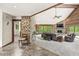 Spacious living room with stone accent wall, wood-paneled ceiling, fireplace, and large windows providing ample natural light at 20322 Wagon Trail Dr, Noblesville, IN 46060
