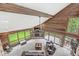 Spacious living room with high ceilings, stone fireplace, and large windows overlooking the yard at 20322 Wagon Trail Dr, Noblesville, IN 46060