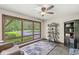 Cozy living room with large windows offering scenic views and a ceiling fan for added comfort at 20322 Wagon Trail Dr, Noblesville, IN 46060