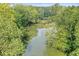 A view of the river surrounded by lush green trees and vegetation at 20322 Wagon Trail Dr, Noblesville, IN 46060