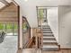 Beautiful staircase with stone accents, wood railings, and a window seat at 20322 Wagon Trail Dr, Noblesville, IN 46060