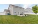 View of a manicured backyard with a patio, grill, outdoor seating, and a privacy fence at 2260 Santa Fe Dr, Greenfield, IN 46140