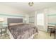 Cozy bedroom featuring striped accent wall, plush bedding, and a window with natural light at 2260 Santa Fe Dr, Greenfield, IN 46140