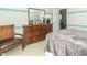 Bedroom view featuring a wooden dresser with a mirror, decor, and view into another room at 2260 Santa Fe Dr, Greenfield, IN 46140