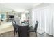 View of dining area featuring a glass table, four chairs, and an open view into the living room at 2260 Santa Fe Dr, Greenfield, IN 46140