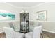 Chic dining area with a glass table, soft gray chairs, and modern lighting fixtures at 2260 Santa Fe Dr, Greenfield, IN 46140