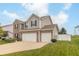 Attractive two-story home features a two-car garage and a neatly maintained lawn at 2260 Santa Fe Dr, Greenfield, IN 46140