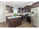Modern kitchen featuring stainless steel appliances, dark cabinets, and a center island with a countertop at 2260 Santa Fe Dr, Greenfield, IN 46140