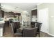 Bright kitchen featuring stainless steel appliances, dark wood cabinets, and a glass table with four chairs at 2260 Santa Fe Dr, Greenfield, IN 46140