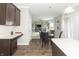 Open kitchen view showing the dining area and living room; with dark cabinets and an island countertop at 2260 Santa Fe Dr, Greenfield, IN 46140