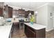 Modern kitchen with stainless steel appliances, dark cabinetry, and a center island with a white countertop at 2260 Santa Fe Dr, Greenfield, IN 46140