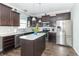 Well-lit kitchen featuring stainless steel appliances, dark wood cabinets, and center island with countertop at 2260 Santa Fe Dr, Greenfield, IN 46140