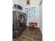 Laundry room featuring front-load washer and dryer on pedestals with shelving and storage at 2260 Santa Fe Dr, Greenfield, IN 46140